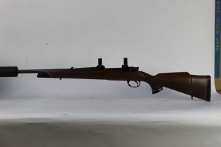 A Parker Hale cal 243 bolt action rifle, fitted with scope rings and a T8 sound moderator,