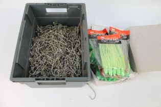 A box of Octopus bait sea fishing lures, and a box of large sea fishing hooks.