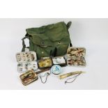 A vintage tackle bag containing two alloy fly boxes containing salmon flies,