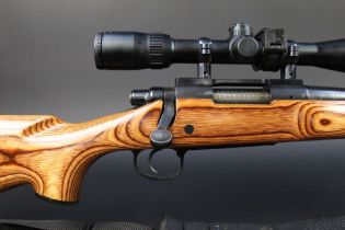 A Remington Model 700 cal 223 bolt action rifle, with a heavyweight bull barrel, laminate stock,