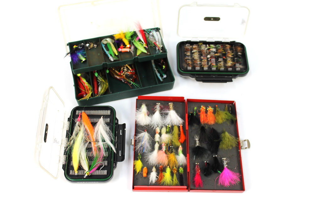 Four boxes of flies, two double sided containing trout and saltwater flies.