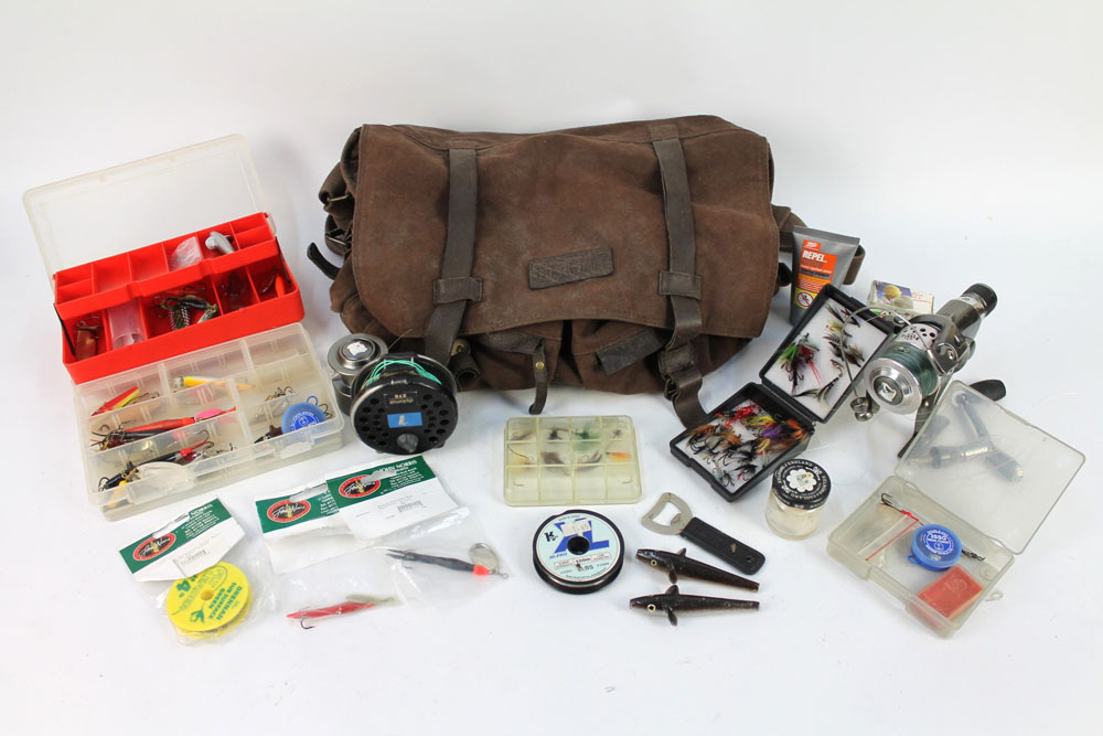 A fishing bag containing a Diplomat 278 fly reel, various boxes containing lures, spinners,