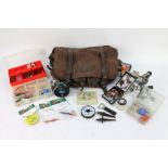A fishing bag containing a Diplomat 278 fly reel, various boxes containing lures, spinners,