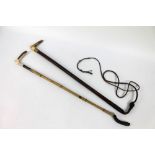 A hunting whip and a riding crop, the crop with antler handle and silver collar,