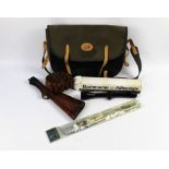 A Jack Pyke game bag containing a Bushmaster scope, shotgun stock, cartridge belt,