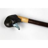 A walking stick with carved wooden handle in the form of an American blue billed duck,