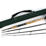 A Shakespeare Trion XT spinning rod, in four sections, 8' with hard rod tube.