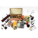 A fly tying kit, to include vice etc, various fly tying materials to include feathers, tinsels etc.