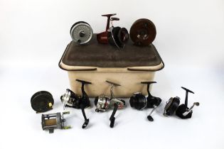 A brown tackle box containing nine vintage reels, to include a Pflueger Supreme multiplier,