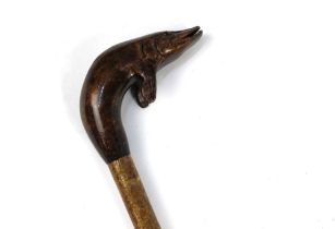 A walking stick with carved wooden handle in the form of a pike, length 124 cm.