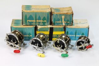 Four Penn multipliers and five Penn reel boxes.