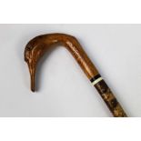 A walking stick with carved wooden handle in the form of a swan, length 133 cm.