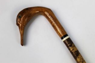 A walking stick with carved wooden handle in the form of a swan, length 133 cm.