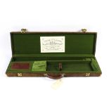 A suede shotgun motor case opening to a green lined interior, suitable for 30" barrels,