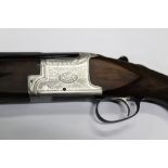 A Laurona 12 bore over/under shotgun, with 17 1/2" barrels, multi choke, comes with four chokes,