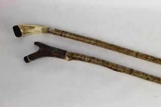 Two hazel shafted walking sticks, first with antler handle,