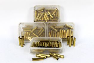 Four boxes of 45.70 brass rifle cartridge cases.