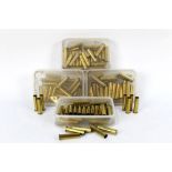 Four boxes of 45.70 brass rifle cartridge cases.