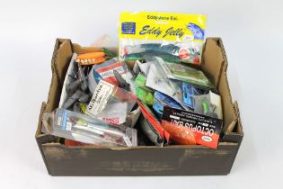 A box containing a large quantity of sea fishing weights, Riggs, to include Octopus bait,