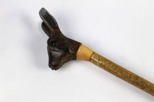 A walking stick with carved wooden handle in the form of a hare, length 127 cm.