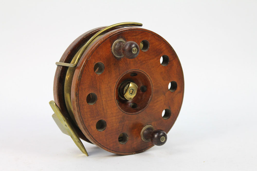 An antique Milward Bartleet of Redditch walnut and brass 7" Overseas fishing reel.