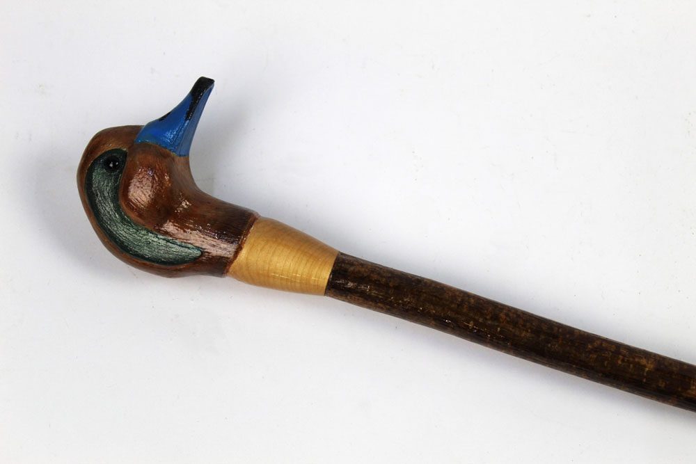 A walking stick with carved wooden handle in the form of a teal, length 123 cm.