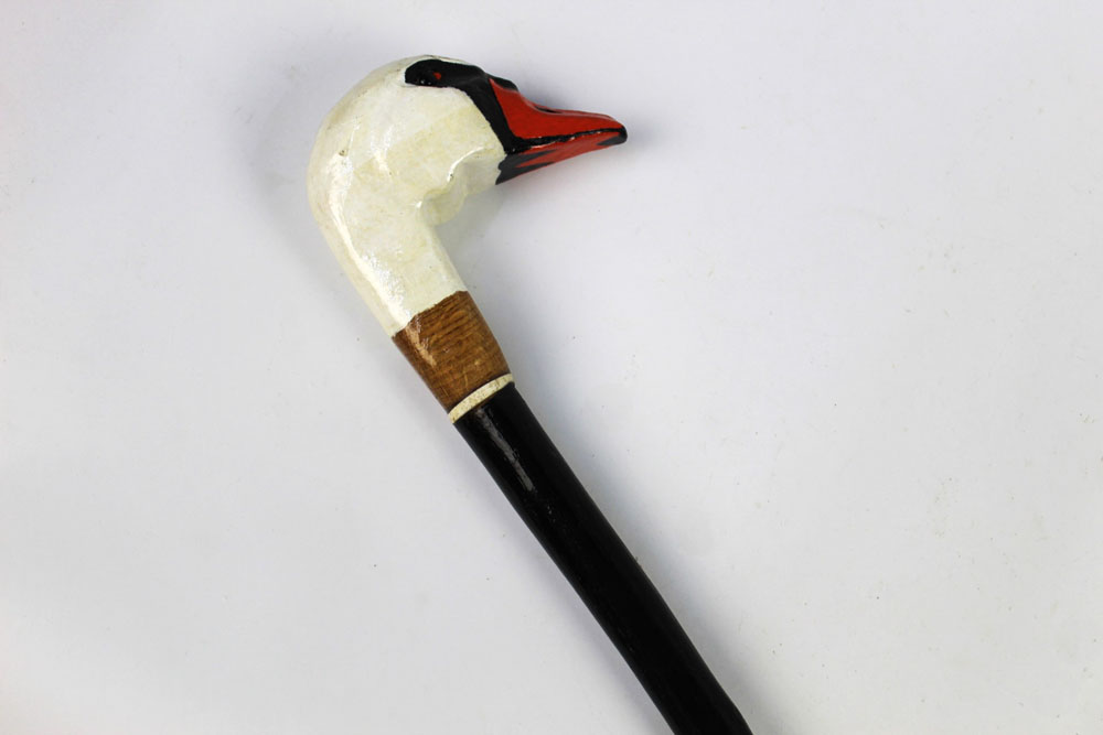 A walking stick with carved wooden handle in the form of a swan, length 136 cm.