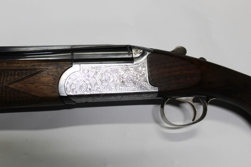 A Browning ? Medalist 12 bore over/under shotgun, with 29 3/4" barrels, multi choke, 70 mm chambers,