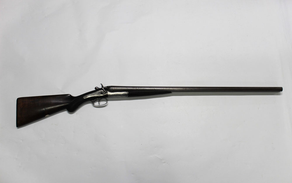 An English side by side hammer shotgun, with 30" Damascus barrels, nitro proof, 2 1/2" chambers,