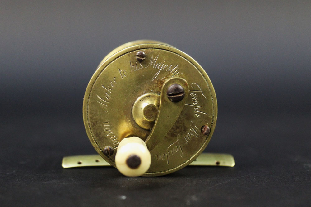 An Ustonson brass pole winch fishing reel, marked to the side Ustonson maker to His Majesty,