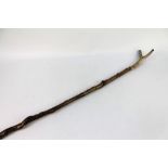 A hazel shafted walking stick with a honeysuckle twisted shaft and stag antler handle.
