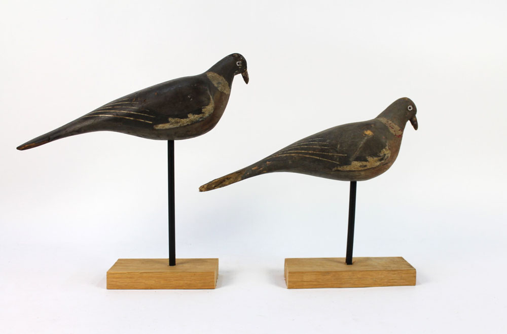 A pair of early 20th century wooden pigeon decoys, in the manner of Francis Rolph of Lakenheath,