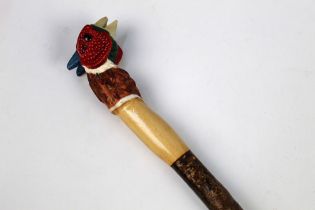 A walking stick with carved wooden handle in the form of a cock pheasant, length 137 cm.