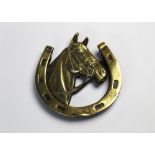 A brass door knocker in the form of a horses head and horseshoe. Length 14 cm, width 13 cm.