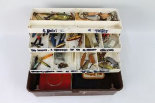 A tackle box containing Nicholson's of Cockermouth spoons, various Abu Koster spoons, Tobys,