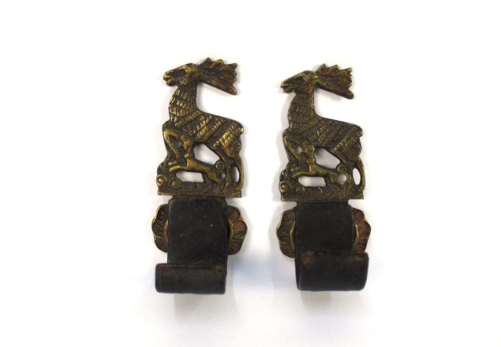 A pair of brass and leather gun wall hanging mounts, decorated with stag and hounds, - Image 2 of 2