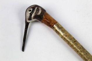 A hazel shafted walking stick, with carved wooden head in the form of a snipe.