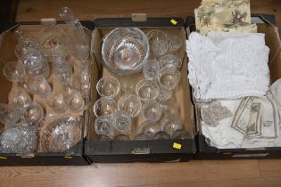 Three boxes of glassware and fabric - tablecloths, embroidered linen,