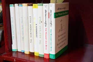 Nine copies of Wainwrights Fell Walking books