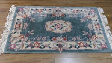 Green floral patterned rug,