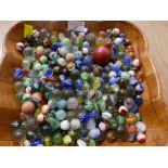 Wooden bowl containing vintage marbles
