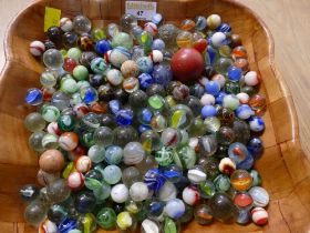 Wooden bowl containing vintage marbles