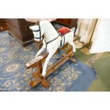 Small wooden Collinson rocking horse on trestle swing stand