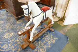 Small wooden Collinson rocking horse on trestle swing stand