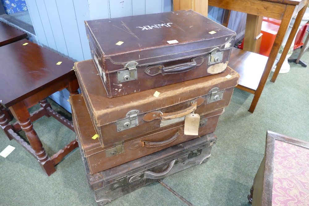 Four vintage leather suitcases, largest 66 cm long, 37 cm wide,