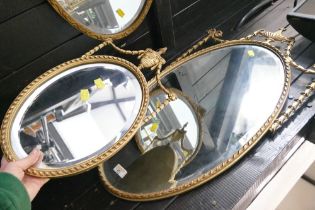 Gilt framed oval bevelled edge mirror and matching smaller mirror,