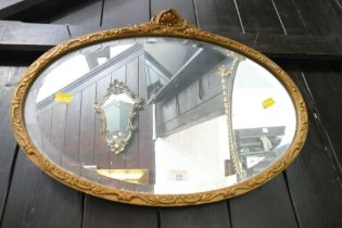 Gilt framed oval bevelled edge mirror,