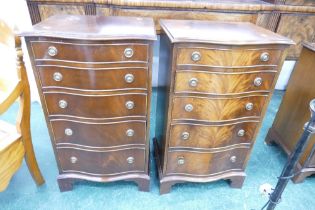 Near pair of serpentine fronted reproduction five flight graduated chests of drawers