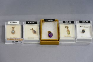 Five 9 ct gold pendants