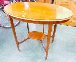 Edwardian oval occasional table with single shelf to base.